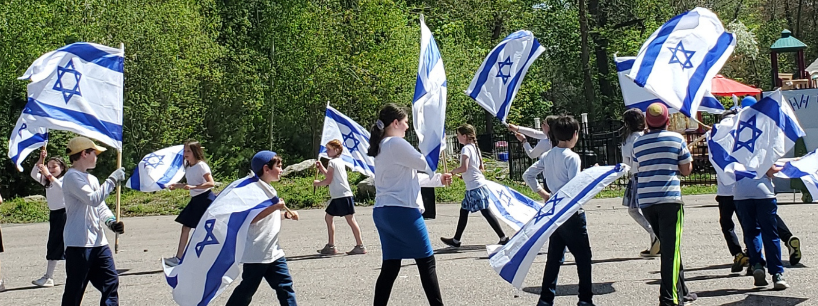 Students dancing with Israeli Flags